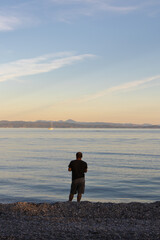 The man is fishing at sea