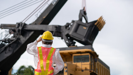 Worker in lignite or coal mining with the truck transporting coal.