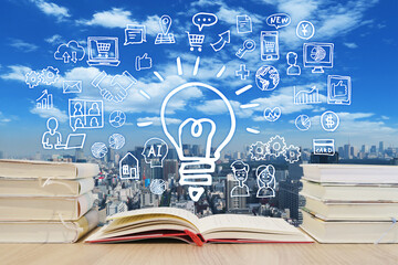 読書で学習する様々な知識・町並みと青空背景-スマホ・パソコン・ネットワーク・ビジネスのアイデア