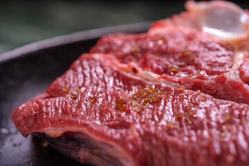 Spiced Raw Fresh Beef For The Steak New York is in a Cast-Iron Vintage Pan. Selective Focus. Closw Up.
