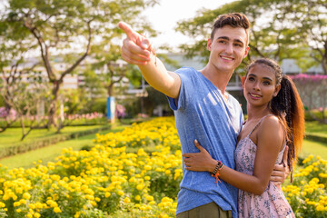 Portrait of young multi ethnic couple relaxing together at the park