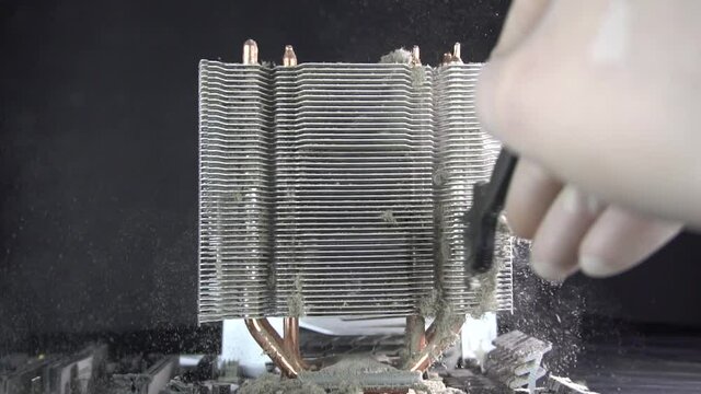 Dust pollution. Cleaning the processor radiator sink from dust. Antistatic brush. Slow motion.