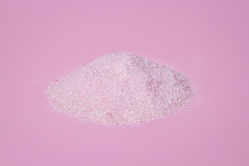 Heap of pink powder on a pink background. Gelatinous dessert mix of pink color, with cherry flavor.