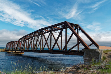 Fototapeta na wymiar The Gut Bridge is an old metal truss railroad bridge located in Stephenville Crossing, Newfoundland and Labrador, Canada.