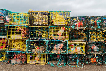 Stacks of lobster pots (traps) at the end of the fishing season, Newfoundland and Labrador, Canada.
