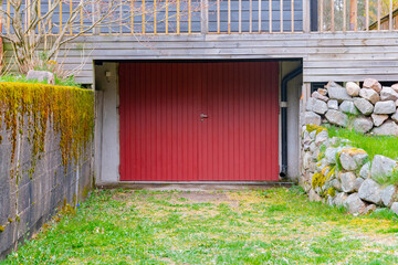 Entrance to the old underground garage with white gates. Garage gate to a private car parking