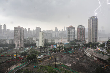 Naklejka na ściany i meble Lightning strikes an apartment block as construction continues in Central Chongqing