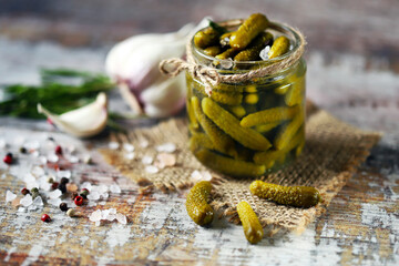 Selective focus. Gherkins. Mini gherkins in a jar. Pickles. Condiments and spices.