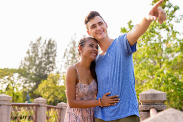 Portrait of young multi ethnic couple relaxing together at the park