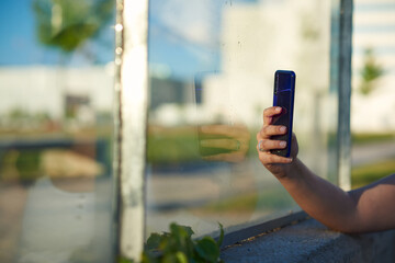 Closed shot of an arm holding a smart phone.