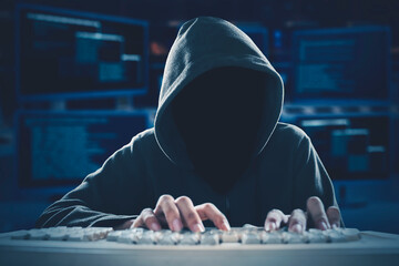 Hacker typing on keyboard with coding background