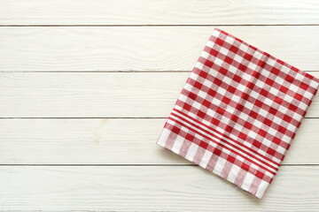 Checkered napkin on white wooden background top view. copy space