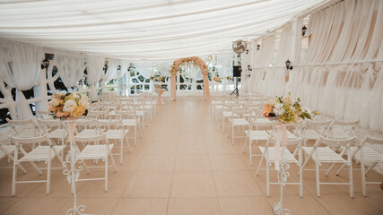 Wedding decor in white and pink color style, zone of wedding ceremony, details of wedding arch, floristics, chairs and a path of rose petals