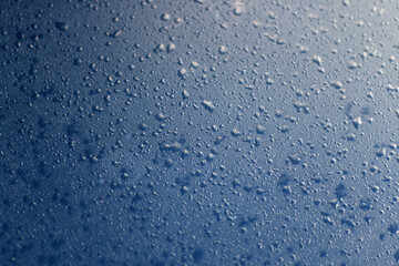 Water drops on blue metal. Water drops background.