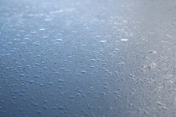 Water drops on blue metal. Water drops background.
