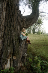 Little girl on a very big tree 