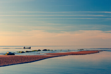 Fishing boat leaves the bay at sea