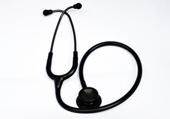 Doctor's stethoscope, black, placed on a white background 