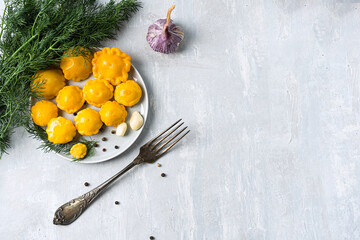 pickled mini squash on display in a homemade kitchen against a light gray stone backdrop