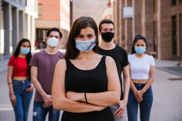 Portrait of a group of young millennial friends with the mask - Tools need to wearing avoid the infection from Coronavirus, Covid-19 - People together - Concept of safety