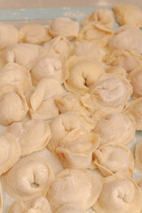 Homemade dumplings are put together on a Board in the kitchen