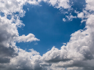 Fototapeta na wymiar Hole of blue sky in the fluffy clouds in the sky