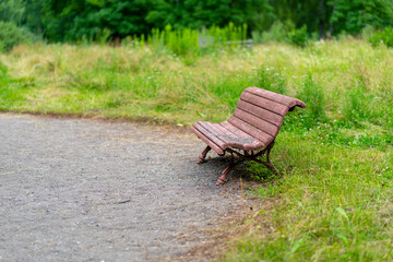 Old wooden bench for rest. Dirty shabby pew in park.