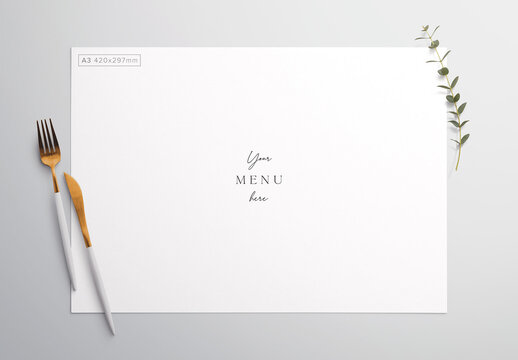 Menu on Table with Cutlery and Eucalyptus Mockup
