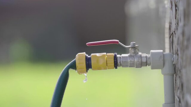 close up. male hand openes street water faucet in the summer