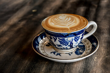 Cup of offee latte art on table