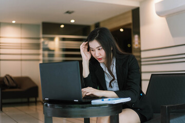 Beautiful young asian  business woman with headache at office