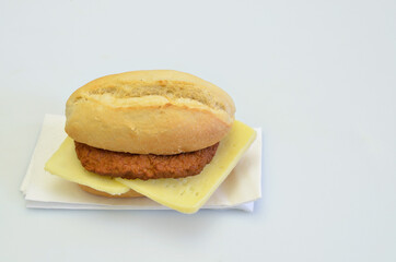 Cheeseburger on white Napkin, isolated on white Background