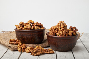 Walnut kernels on a wooden background.