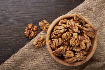 Walnut kernels on a wooden background.