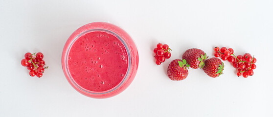 Jam of strawberries and red currants on a white background. Isolated. Banner.