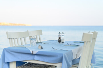 cafe tables on the sea mediterranean embankment. selective focus