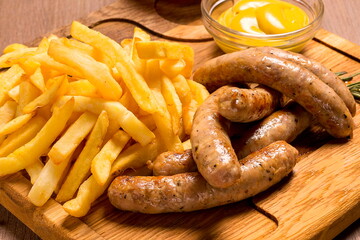 Grilled sausages with french fries with ketchup and mustard