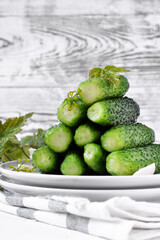 Light-salted cucumbers forming a pyramid against the white background