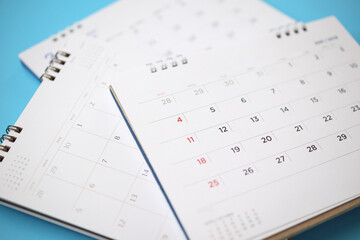 Naklejka na ściany i meble calendar page close up on blue background business planning appointment meeting concept