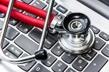 Stethoscope on a computer keyboard. Computer technology is an integral part of medicine, healthcare, and medical health insurance today.