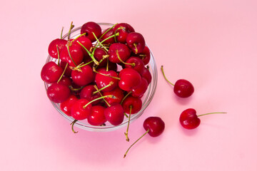 Obraz na płótnie Canvas red cherries on pink background