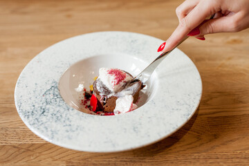 Red sweet dessert on a white plate. Sweetness on a beautiful dish. Sweet cake