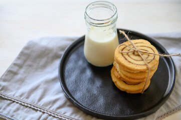 Shortbread cookies with cinnamon and a glass of milk. Selective focus.