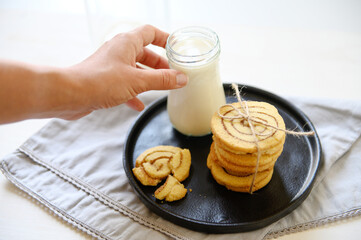 Shortbread cookies with cinnamon and a glass of milk. Selective focus.