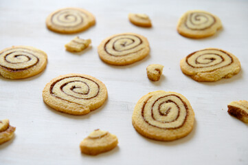 Shortbread cookies with cinnamon on a white wooden background. Cookie pattern. Selective focus.