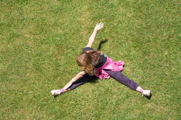woman with medical mask doing gymnastics on the grass, new normal concept