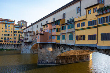 Fototapeta na wymiar The Ponte Vecchio or Old Bridge. medieval stone closed-spandrel segmental arch bridge over the Arno River, in Florence, Italy. italian bridge with houses and shops