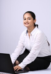 Indian business woman with her laptop isolated on white background.