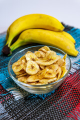 Healthy snacks dry bananas in a bowl. Dried fruits. vertical photo