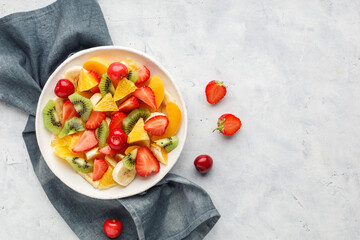 Fresh chopped fruit salad in a bowl. Top view.